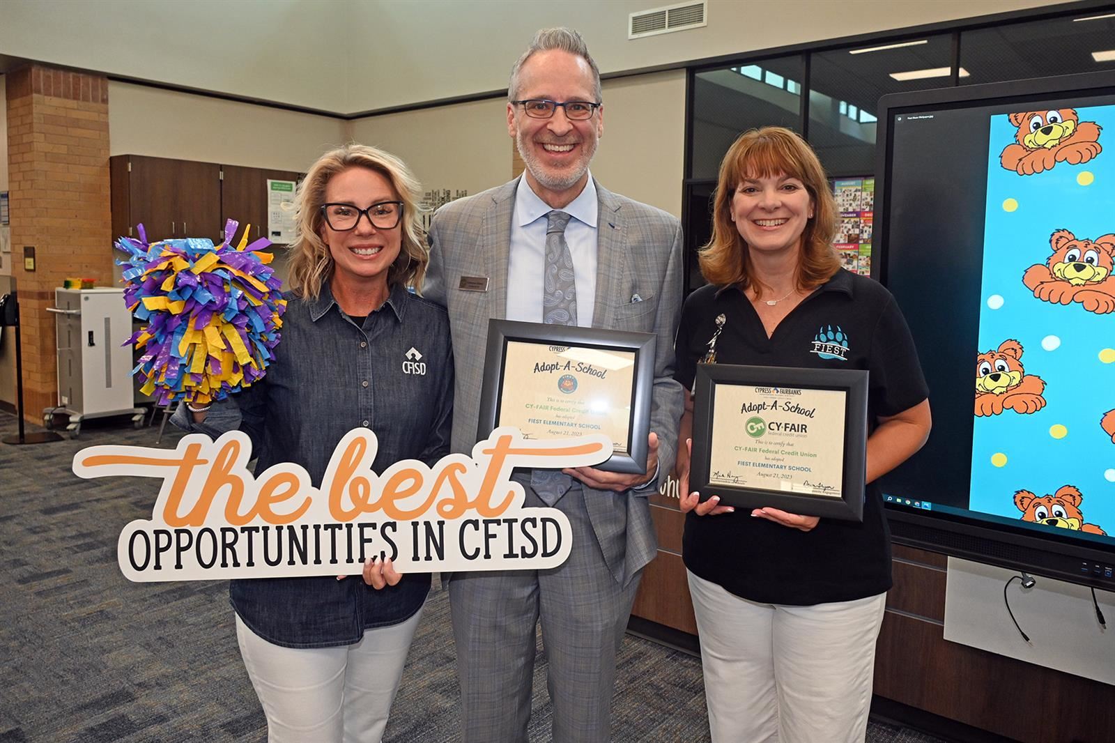 Dr. Jeanette Gerault, Fiest principal, and Cameron Dickey, Cy-Fair Federal Credit Union president, hold certificates.